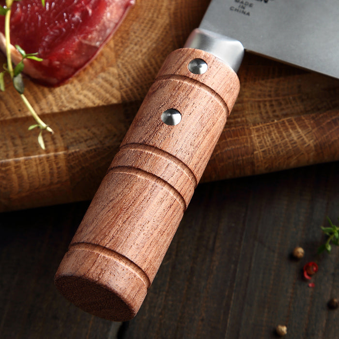 Wooden-handled knife on a wooden cutting board with a blurred background